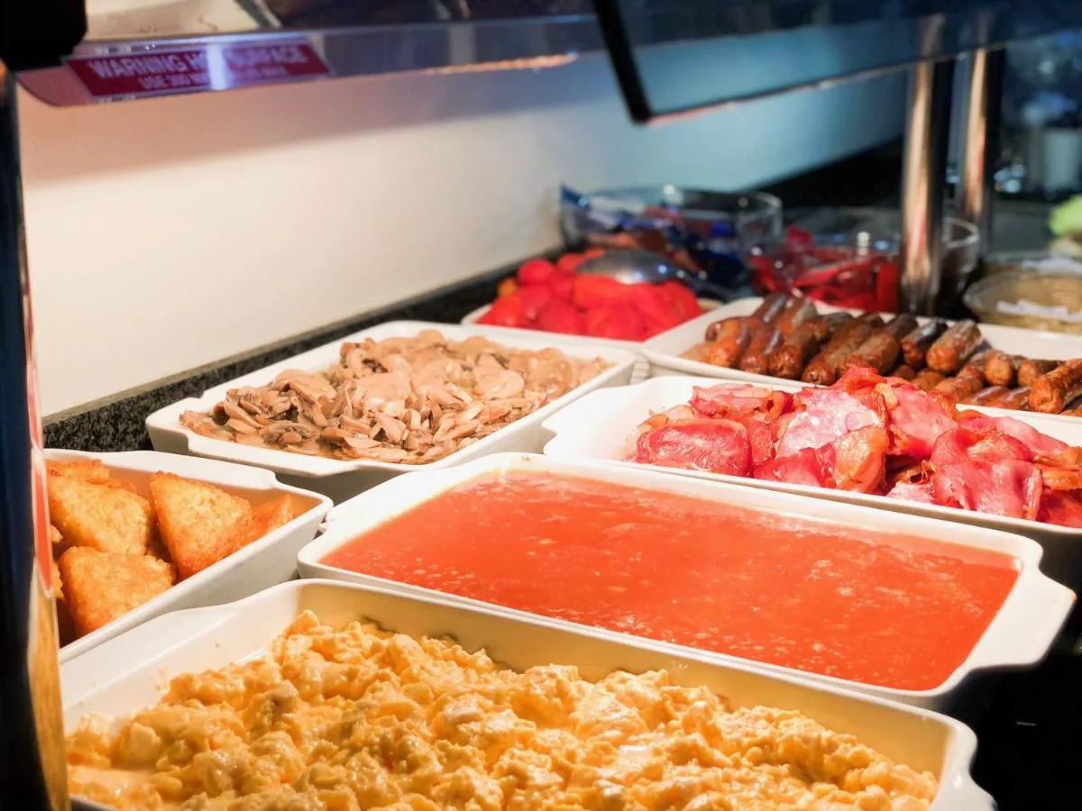 a buffet of different types of food in trays at Park Avenue Bayswater Inn Hyde Park in London